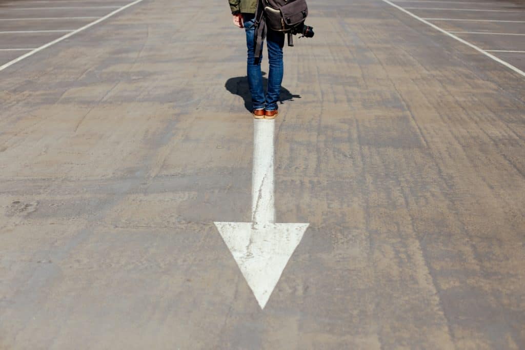 person standing be arrow pointing forward