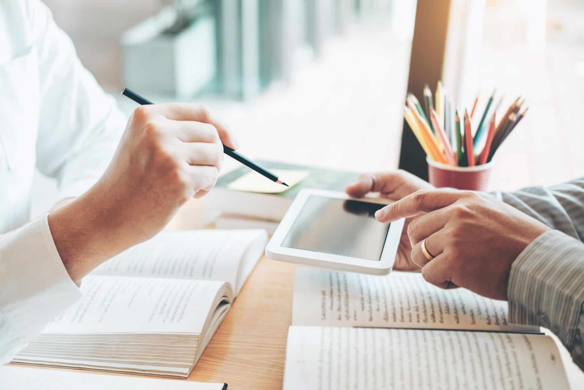 two people tutoring at a desk