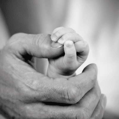 dad holding baby daughter's hand