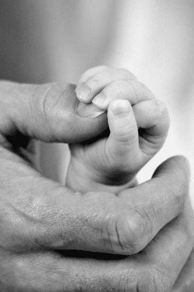 dad holding baby daughter's hand