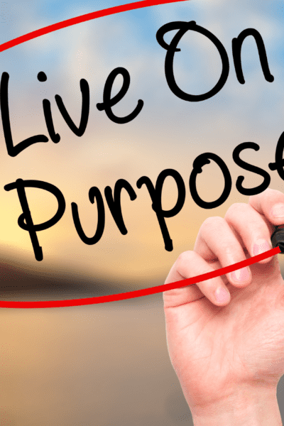 Hand writing "Live on Purpose" with a black marker